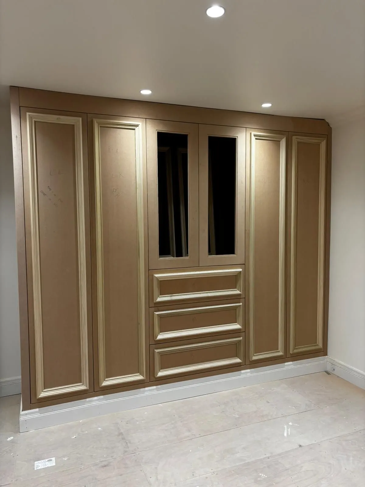 Wardrobe finished in a warm bronze metallic tone