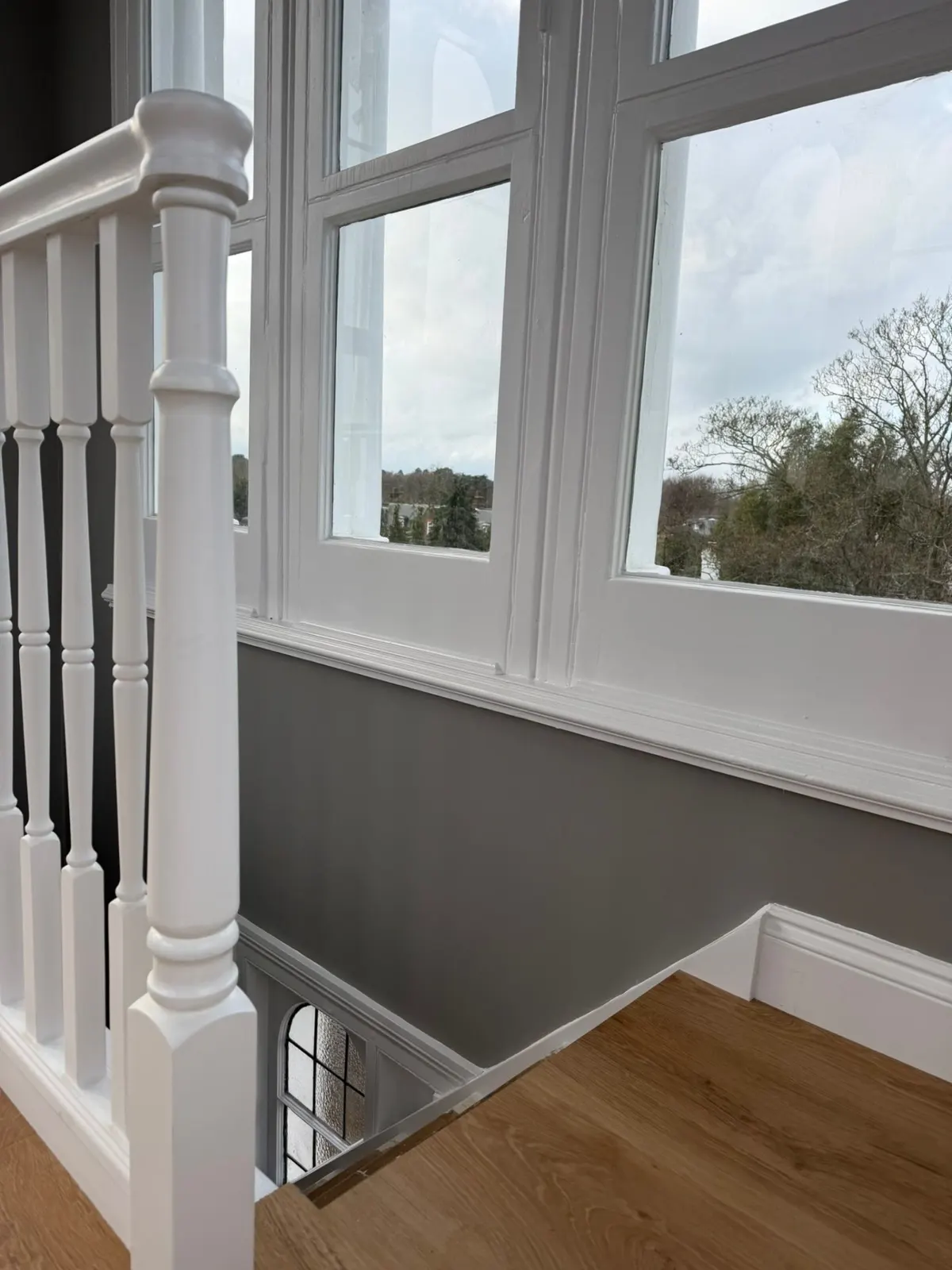 Finished landing with white balustrade and grey walls