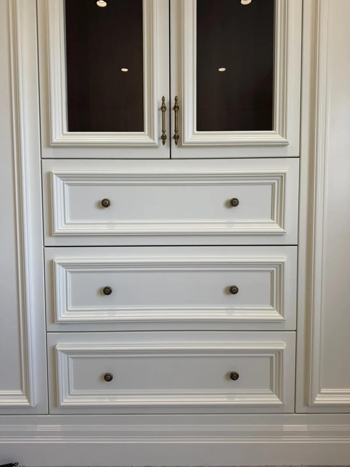 White cabinetry with glazed upper doors and drawers