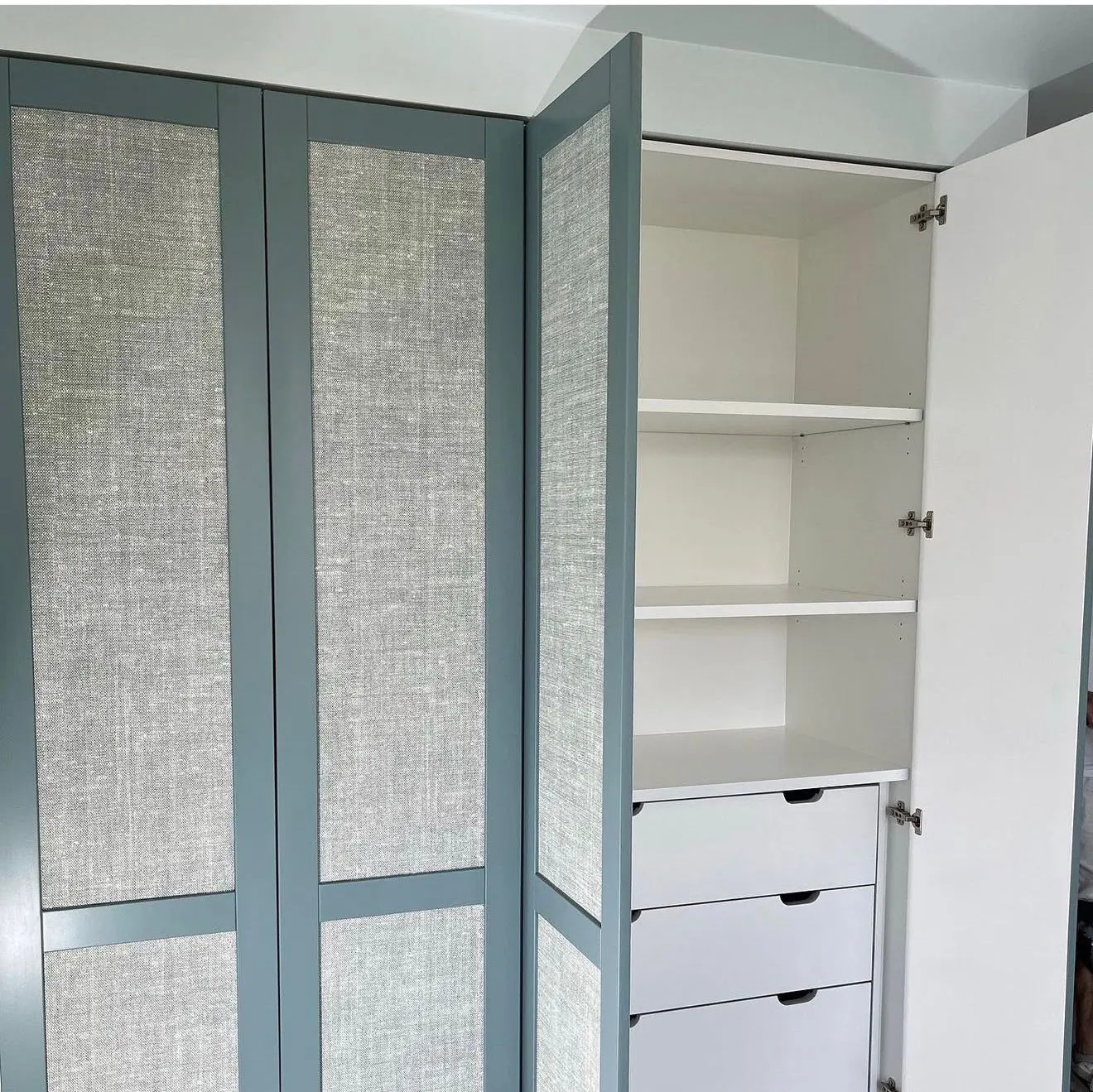Teal wardrobe doors with textured fabric inserts