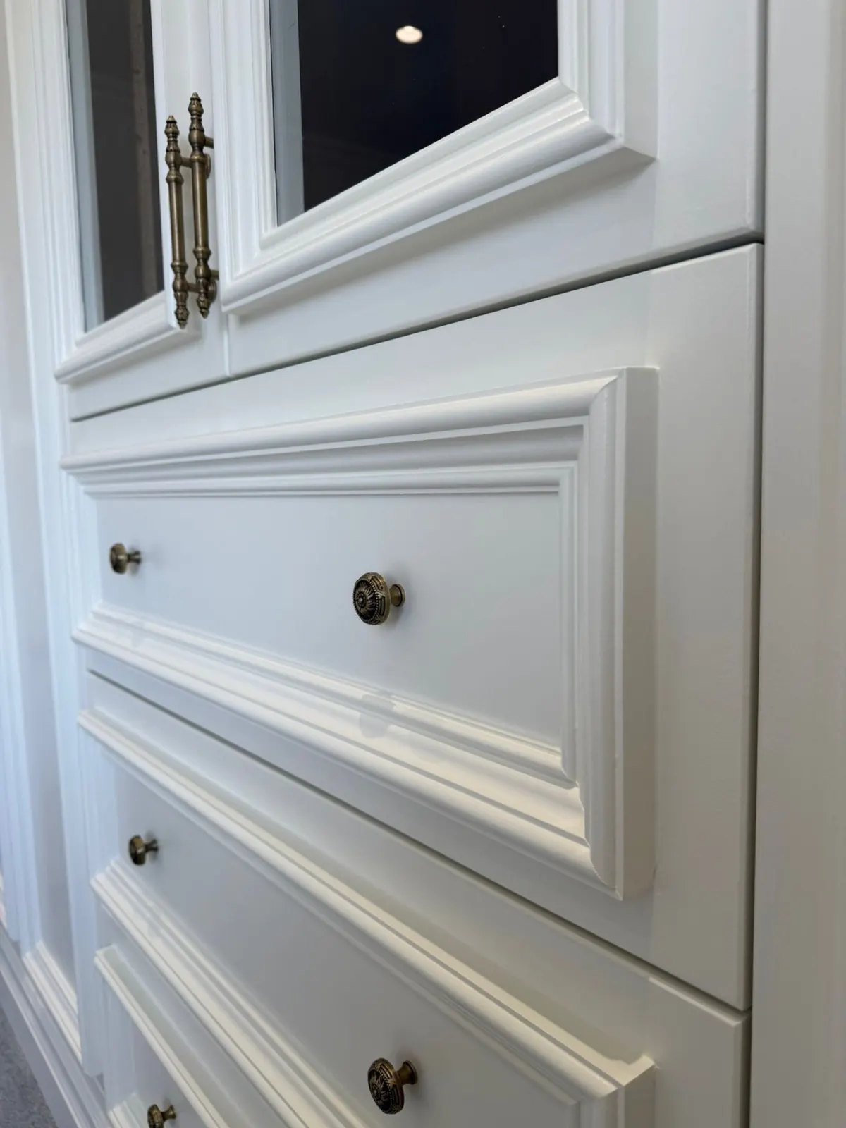 Panelled drawer fronts with brass knobs