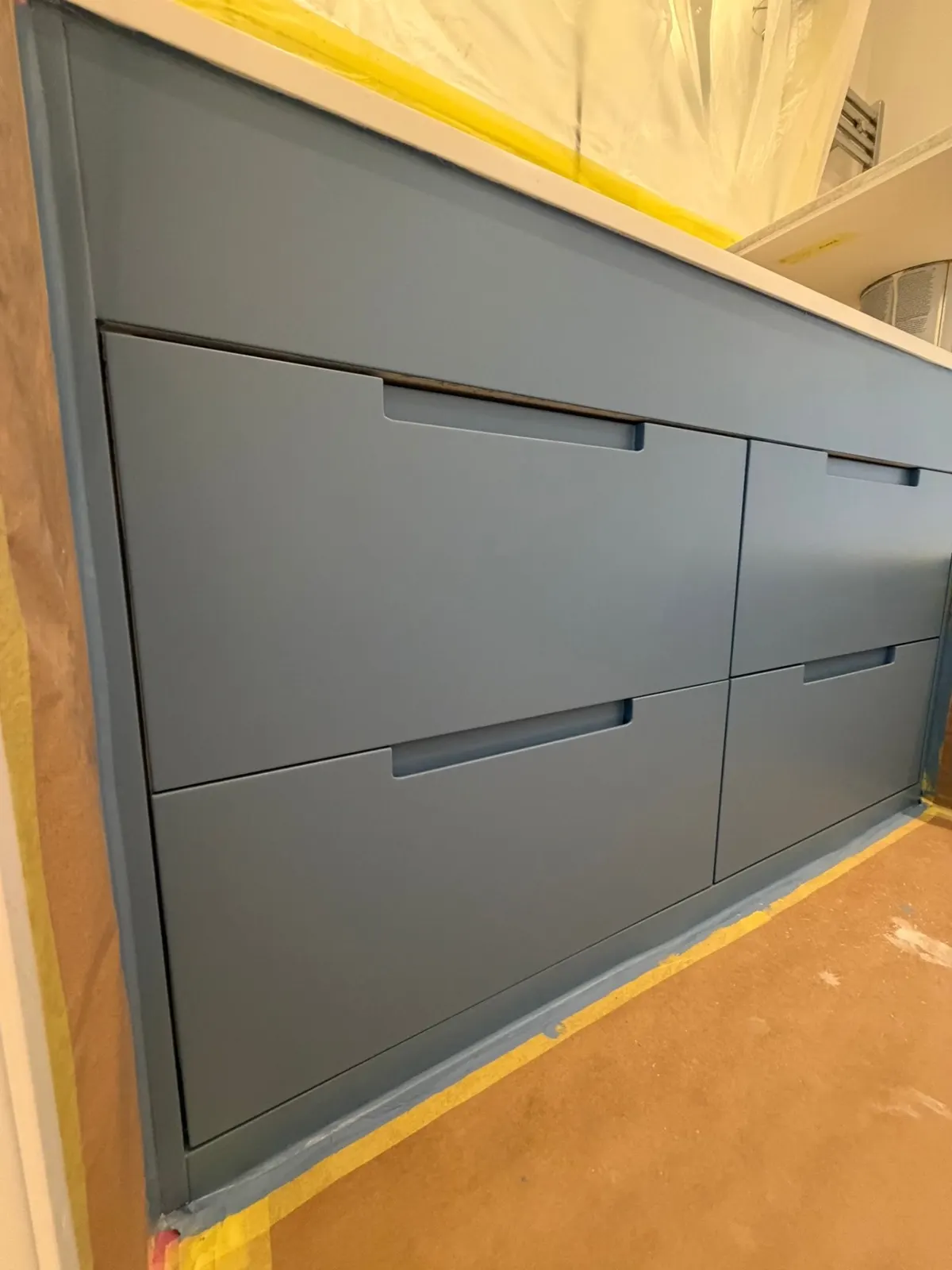 Blue-grey fitted vanity with a smooth sprayed finish
