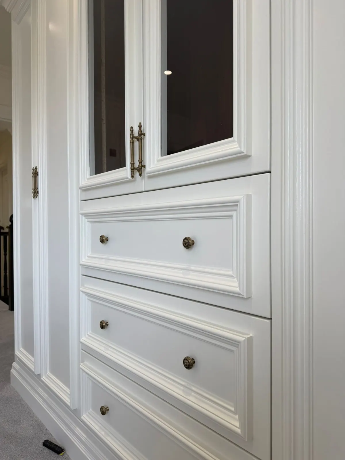 White panelled wardrobe with dark brass handles